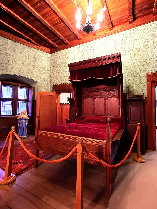 A historic bedroom with a canopy bed at Bojnice Castle