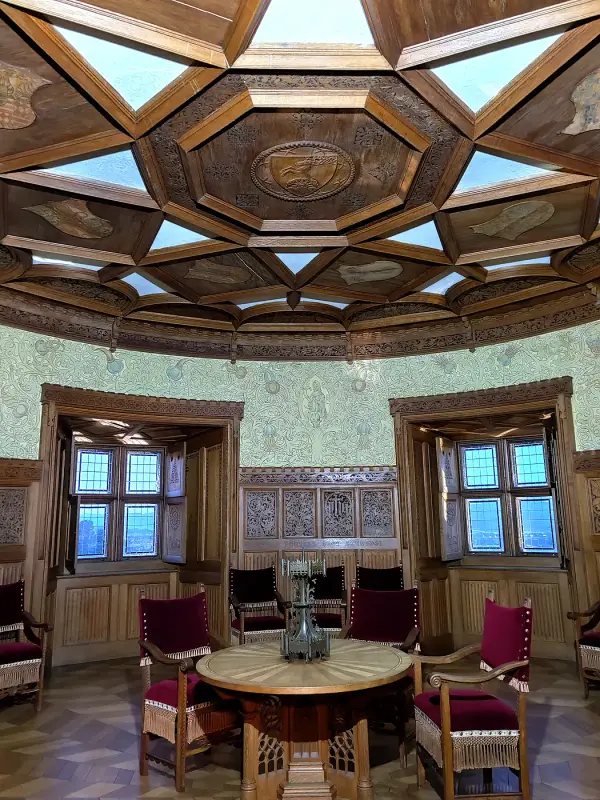 An octagonal tower room with a wooden coffered ceiling